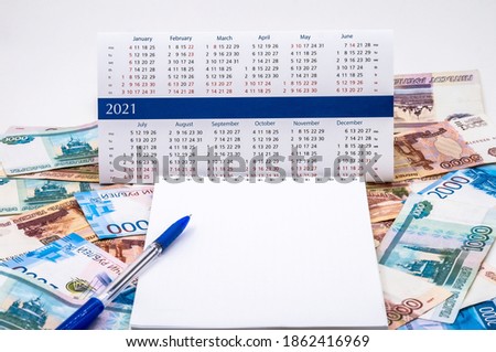budget planning, sales strategy for the next year, Notepad and money, calendar for 2021