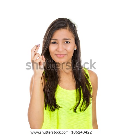 Closeup portrait, young funny looking woman crossing fingers, wishing, praying for miracle, hoping for the best, isolated white background. Positive emotions, facial expressions feelings attitude