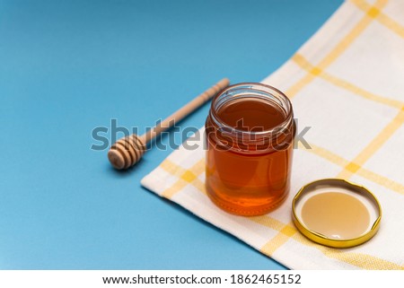 Mono floral natural Honey with a bottle pouring tabletop composition honeycomb with a honey spoon, honey dripper multi background, wood background, white background with a bowl, natural sweetener