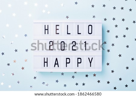 Lightbox with text HELLO HAPPY 2021 on blue background. Top view. New year celebration. Happy New Year 2021 concepts - Image