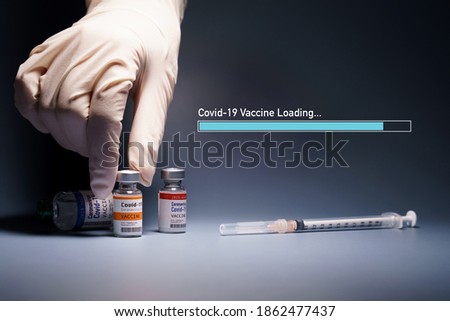 Covid-19 Vaccine Research and Development - Global trial phase 3 concept. Hand of a researcher take a 2019-nCov vaccine vial with loading bar and syringe needle beside. Hope, Support, Successful.