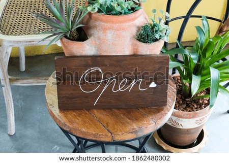Open sign made of wood.