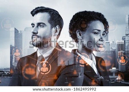 Businessman and businesswoman as a SMM specialists thinking about development of social media marketing strategy to achieve business goals. Hologram icons over Singapore background.