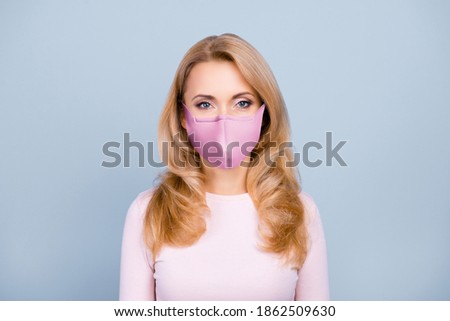 Close-up portrait of nice attractive girl wearing safety reusable mask stop disease influenza isolated over grey blue background