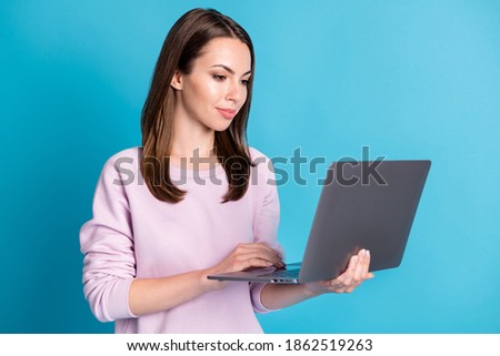 Photo of attractive student programmer lady hold notebook hands modern technology user doing homework website online wear casual purple sweatshirt isolated blue color background