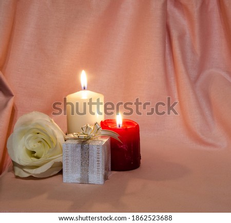 Congratulations on the holiday. Postcard with candles and a rose