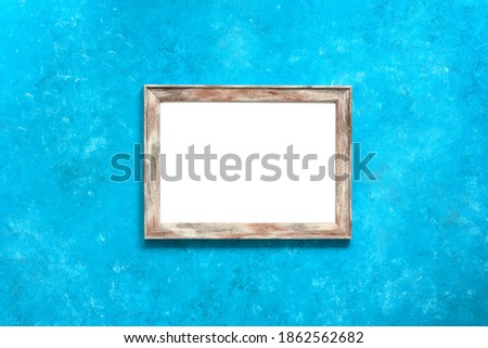 Blank white photo frame mock up on turquoise blue grunge background. Template for your design