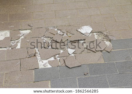Texture of breaking floor tiles outside building