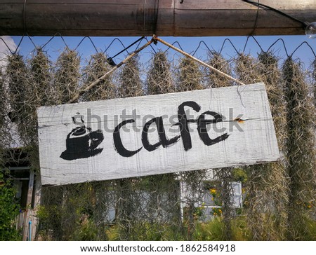Old wooden sign coffee shop.