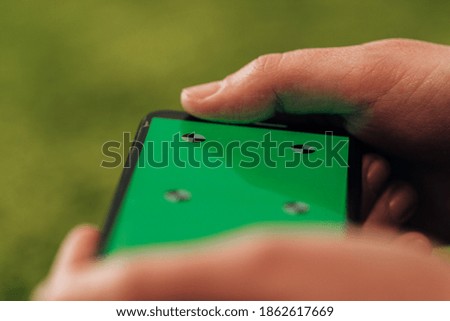 Girl Holds An New Smart Phone In Her Hand. Chroma Key Green