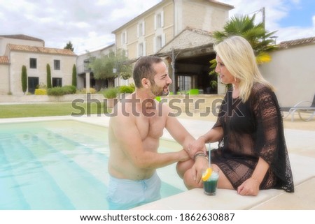 Portrait of an accomplice couple in their private pool