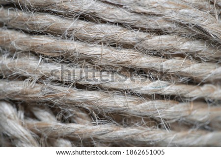 High-quality handmade coil made of natural hemp rope, isolated on a background. Rustic beige cord made of eco material