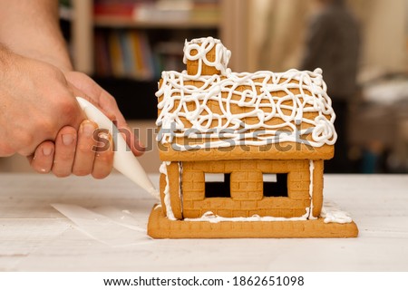 Decorating, cooking, slaking a gingerbread house. Preparation for Christmas.