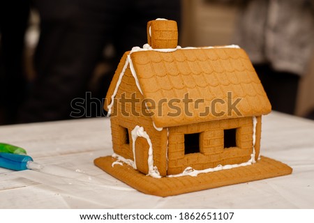Decorating, cooking, slaking a gingerbread house. Preparation for Christmas.
