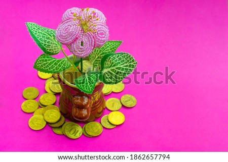 Cash flow concept. Blooming Money tree with benefits, dropped money coins on bright pink background with space for text. Copy space