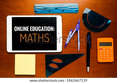 Flatlay picture of tablet with Online Education: Maths word, pen, notepad and geometry set on table.