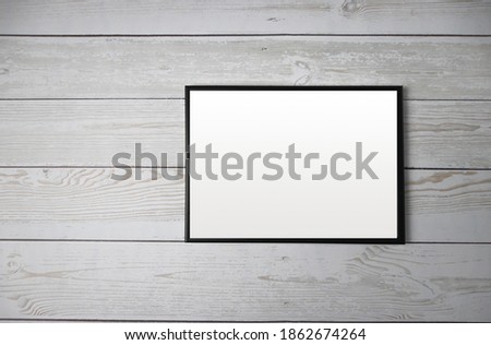 Mockup black frame photo on a wooden background top view. horizontal empty black wooden frame