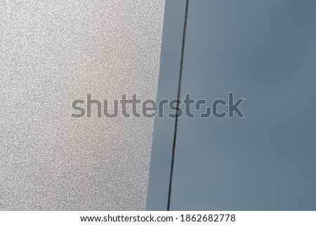 Closeup Frosted Glass Thick Film for reduces visibility across. Toilet wall sticker bathroom decoration. Office films privacy for bathroom Office meeting room.
