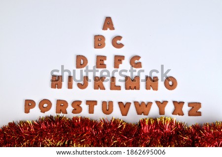 Gingerbread christmas alphabet with Christmas decorations and attributes on the white background
