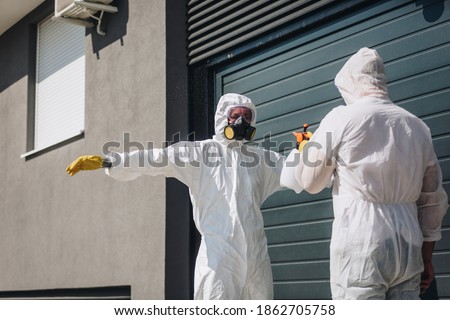 A worker in a sterile uniform and mask clean up before work Disinfected the whole building from covid-19 coronavirus.