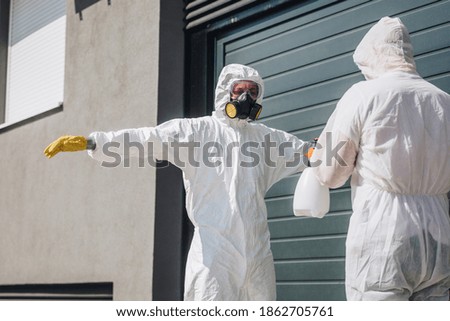 A worker in a sterile uniform and mask clean up before work Disinfected the whole building from covid-19 coronavirus.