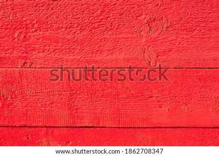 the bright red background of wooden boards