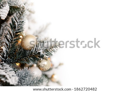 Merry Christmas and Happy New Year. Golden ball on christmas tree branch, free space, isolated on white background