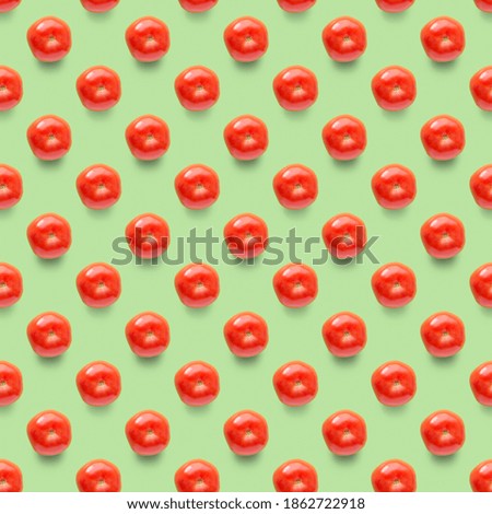 Red tomatoes on green background. Composition for seamless pattern. Food concept.