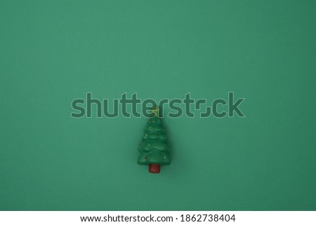 Toy tree green background. New Year's decor. Copy space, mock up