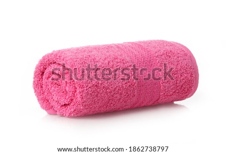 Soft pink towel rolled up on white background