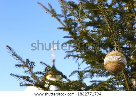 Christmas tree branch on the background of the Orthodox icon and the cross. Orthodox Church Winter - Christmas. The concept of Orthodoxy