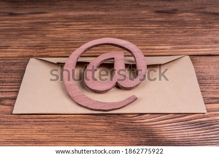 Email symbol on a vintage written envelope. Concept message, letter, e-mail