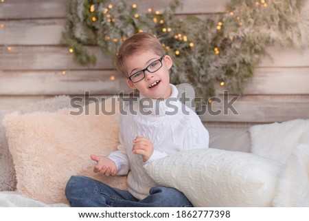 Emotional boy with down syndrome on a winter Christmas porch.