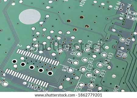 Green PCB with SMD chip solder pads without any components, many test points high depth of field. Clean printed circuit board.