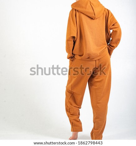 orange sports warm suit on a model, unrecognizable on a white background