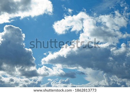 Clouds in blue sky. White, fluffy clouds In blue sky. Background nature. Texture cumulus floating on blue sky. Environment, atmosphere. Place for banner, site an inscription text or logo. Copy space