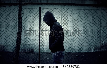 Young street gang with mask in park, social problem Royalty-Free Stock Photo #1862830783