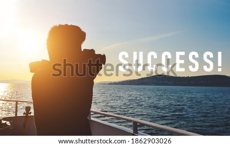 silhouette of a young man taking a photo of water landscape with DSLR camera from a boat with "Success" text. Concept of success, hobby, photography, and entrepreneurship, also good for copy space