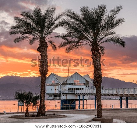 Sunrise on a public beach of Eilat - famous tourist resort and recreational city in Israel