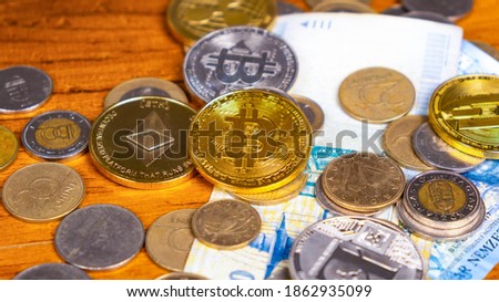 various cryptocurrency coins on paper banknotes close-up, virtual money, business concept, finance.