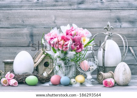 Easter decoration with tulip flowers and pastel colored eggs. Retro style toned picture