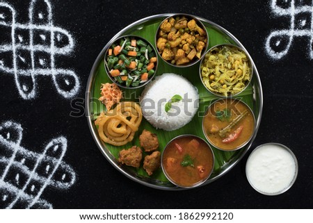 Traditional South Indian Meal or food served on big banana leaf, Food platter or complete thali. selective focus Royalty-Free Stock Photo #1862992120