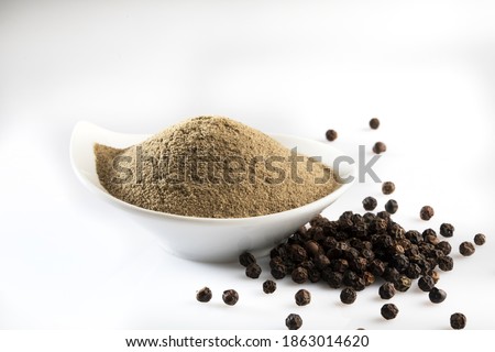 pepper powder,black pepper on white and orange wooden background Royalty-Free Stock Photo #1863014620