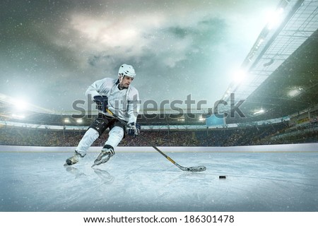 Ice hockey player on the ice. Open stadium - Winter Classic game. Royalty-Free Stock Photo #186301478