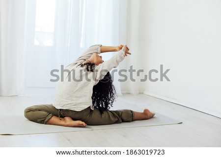 Brunette woman engaged in yoga asana gymnastics flexibility body