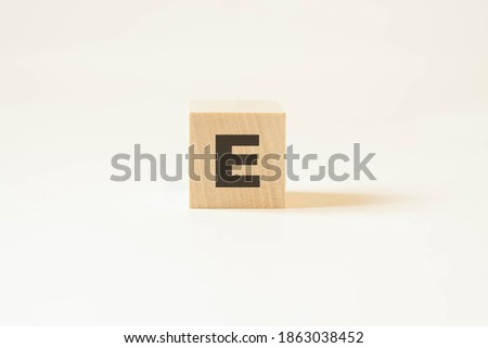 English letter E on a cube on a white background.