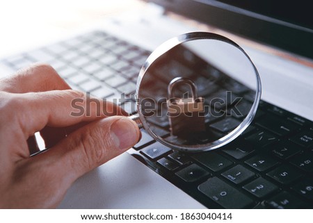 Magnifying glass search open or password on laptop