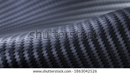 Carbon fiber composite raw material. Texture panorama of black carbon fiber.