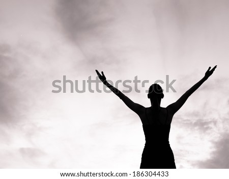 Happy woman celebrating with arms stretched. 