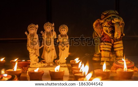 Lord Ram and colorful Elephant made with clay idol brightening with Diya candle light on the occasion of Diwali. Diwali is the major festival of lights in India. Royalty-Free Stock Photo #1863044542